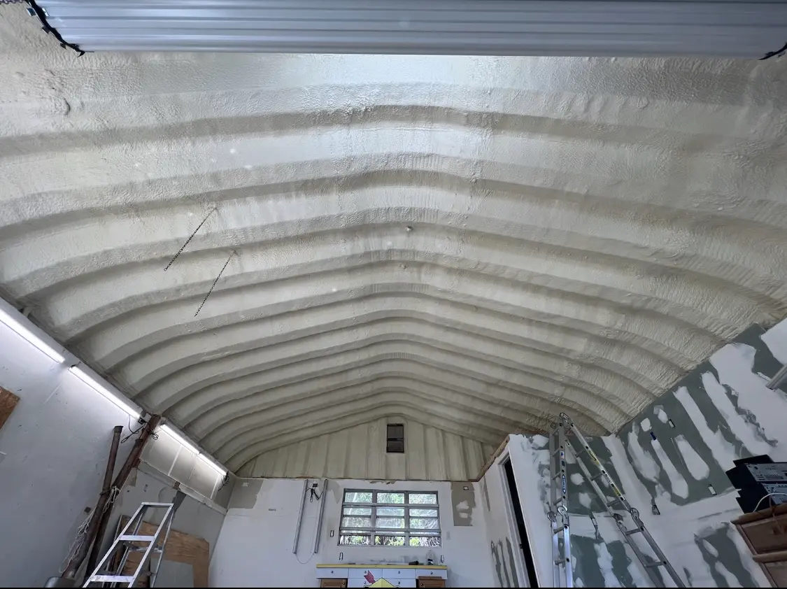 Spray polyurethane foam applied to the underside of a metal roof deck in Woodlawn